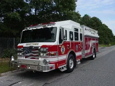 Front-left exterior view showing bumper, wheel area, and side compartments