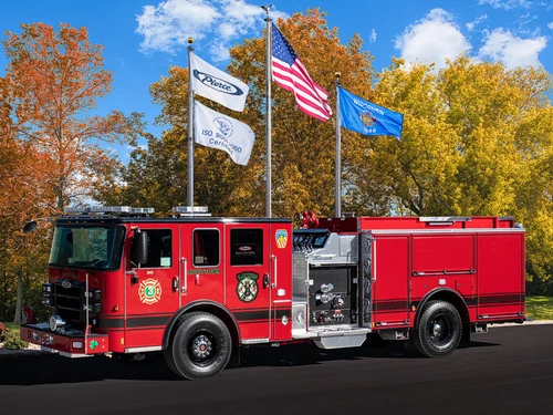 Pumper driver-side profile view showing side compartments and enclosed cab