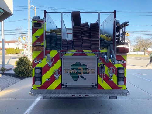 Rear view showing red-and-yellow chevrons and upper rear hosebed area