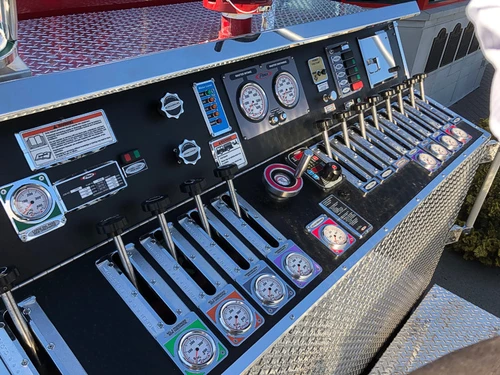 Pump panel close-up showing gauges, valves, and control levers