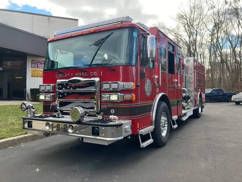 Pumper front-right exterior view showing cab, grille, and pump-panel side body
