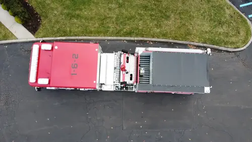 Aerial top-down side view showing full apparatus length and compartment arrangement