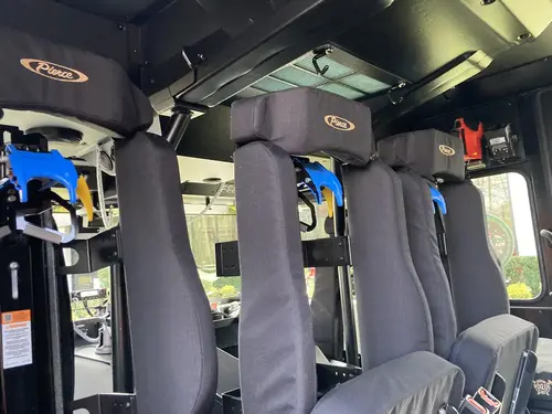 Open compartment over rear wheel showing shelves and wheel well area