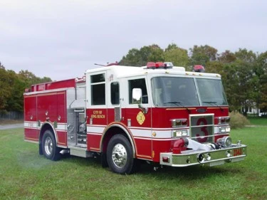 Pumper front-left exterior view showing enclosed cab and side compartments