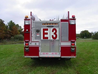 Rear view showing rear door panel, warning lights, and hosebed area