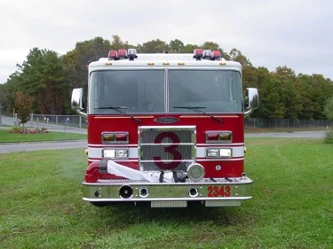 Front exterior view showing grille, bumper, and warning lights