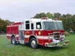 Front-left exterior view showing bumper, cab, and side compartments