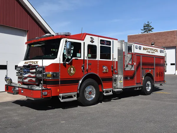 Pumper front-left exterior view showing enclosed cab and side compartments