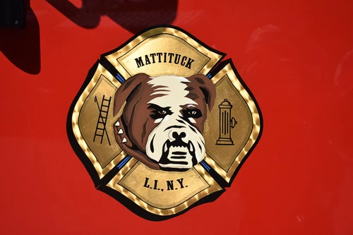 Cab door crest close-up showing circular emblem on red paint
