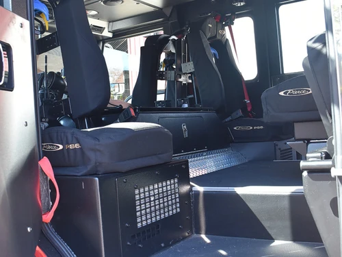 Cab interior view showing rear seats, aisle, and side paneling