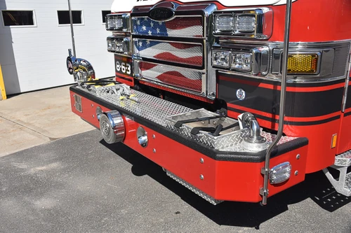 Front bumper close-up showing intake fittings, grille, and chrome trim