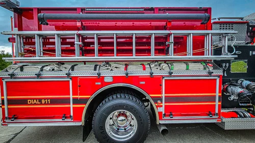 Driver-side profile showing side compartments and upper hosebed area