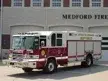 Wide front left shot of the heavy rescue parked in front of the station.