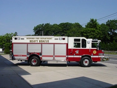 Full right-side profile of the heavy rescue body with compartment layout and wheel/tire areas.