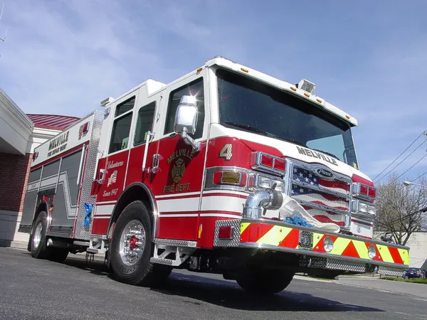 Low front-left exterior view showing bumper, cab, and side compartments