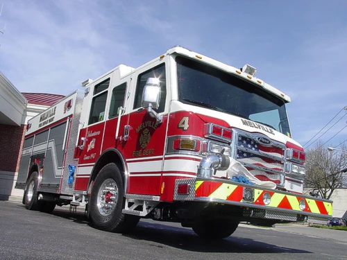 Low front-left exterior view showing bumper, cab, and side compartments