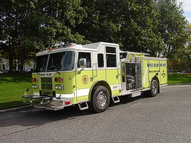 Front-left exterior view of a lime pumper showing enclosed cab, side pump panel section, and rear body.