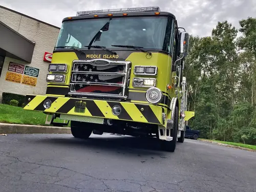Pumper front-right exterior view showing cab, bumper, and side compartments