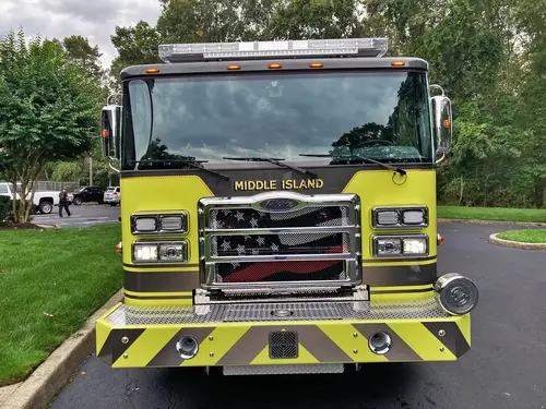Front-right exterior view showing cab corner, front wheel, and side body