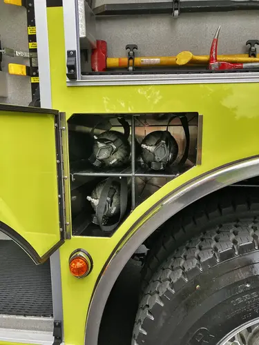 Rear-left exterior view showing side body panel and hosebed rails