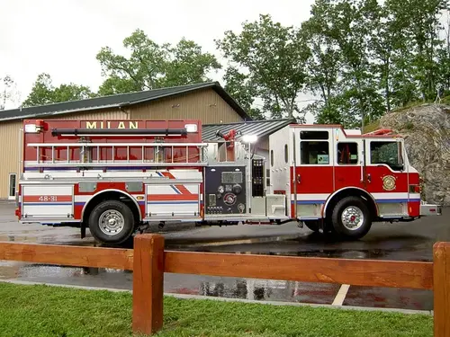 Driver-side profile view showing side hosebed rails and pump panel area