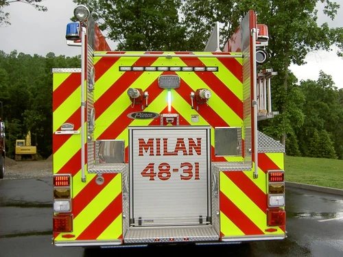 Rear view showing chevron striping, rear door panel, and warning lights