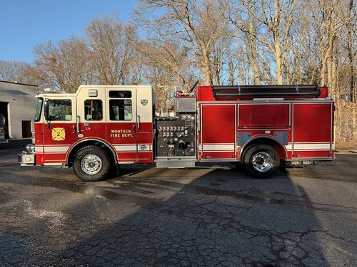 Pumper front-left exterior view showing cab, side compartments, and front wheel area