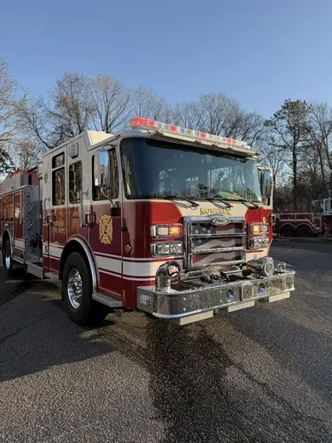 Front-left exterior view showing grille, bumper, and side body striping