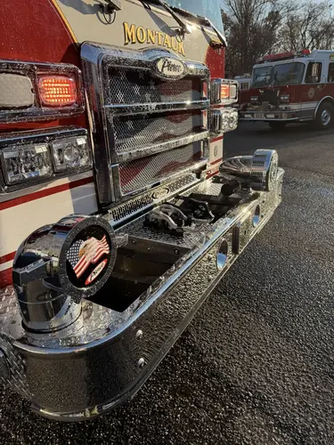 Front bumper hardware close-up showing intake fitting and chrome trim