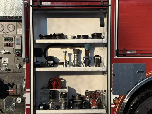 Open side compartment showing shelves with hand tools and storage bins