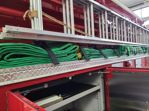 Open long side compartment showing coiled hose in horizontal rack