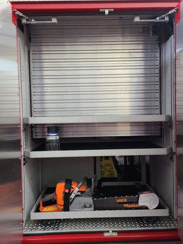 Open side compartment showing pull-out tray with tool storage