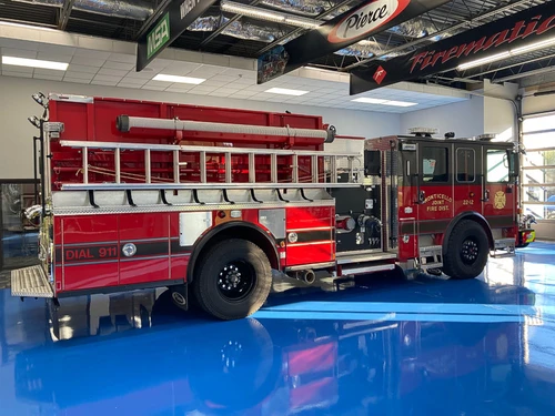 Driver-side profile view showing pumper body and rear wheel area