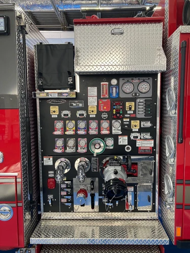 Pump panel close-up showing gauges, valves, and intake controls