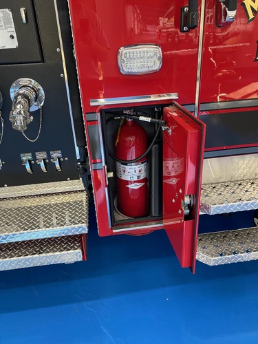 Open narrow side compartment showing extinguisher and side shelf