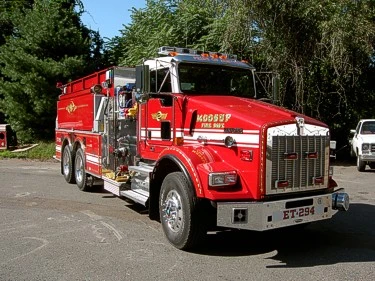Front-right exterior close-up showing grille, bumper, and front wheel area