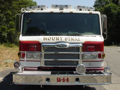 Front exterior view showing grille, bumper, and warning lights