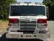 Front exterior view showing grille, bumper, and warning lights