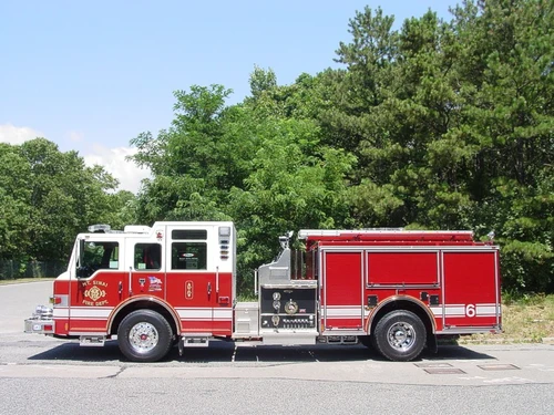 Driver-side profile view showing side compartments and pump panel area