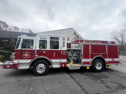 Pumper driver-side profile view showing side compartments and wheel area