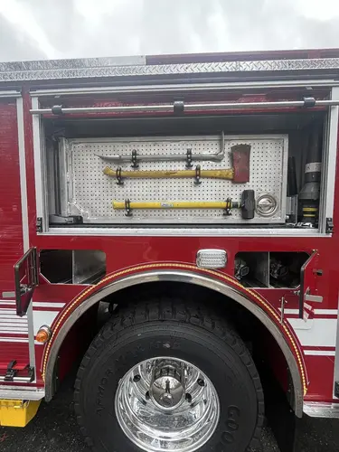 Open side compartment showing mounted hand tools in horizontal rack