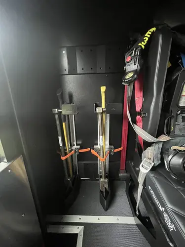 Cab interior side view showing rear seat and side equipment mounts