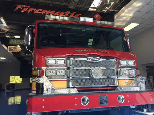 Head-on front view showing grille, warning lights, windshield, and front intake ports.