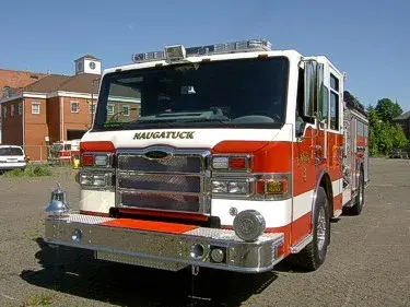Pumper front-left exterior view showing enclosed cab and side compartments