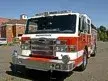 Pumper front-left exterior view showing enclosed cab and side compartments