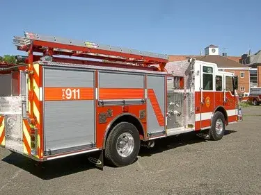 Rear-right exterior view showing side hosebed rails and rear body panel