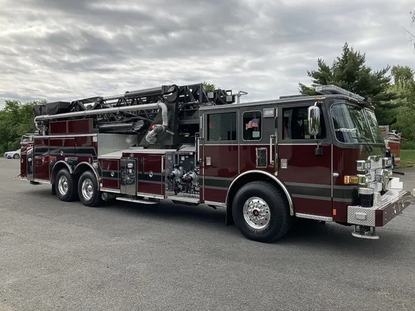 Tower ladder truck front-left exterior view showing long ladder body