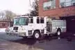 Wide front right view of the parked pumper showing full cab and side body.