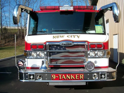 Head-on front close-up showing grille, windshield, warning lights, and front bumper fittings.