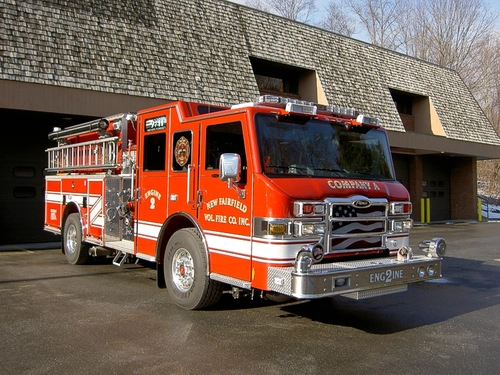 Pumper front-left exterior view showing enclosed cab, bumper, and side compartments